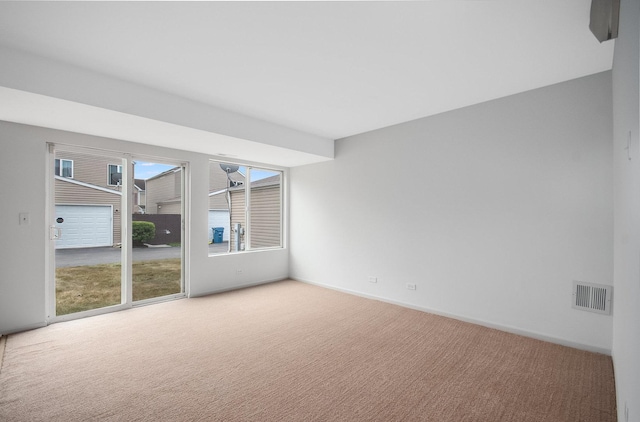 spare room with visible vents, carpet flooring, and baseboards