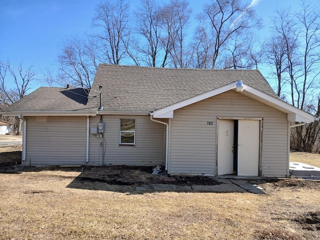 exterior space with roof with shingles