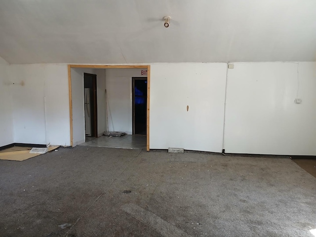 unfurnished room featuring vaulted ceiling