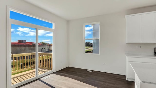 dining area with visible vents, baseboards, and dark wood-style flooring