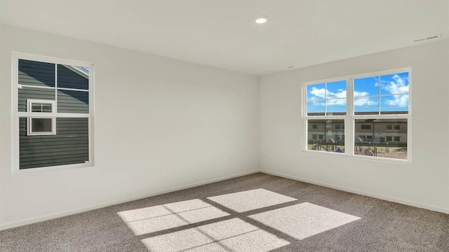 empty room with recessed lighting, visible vents, baseboards, and carpet floors