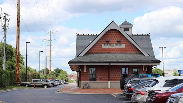 view of building exterior featuring uncovered parking