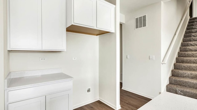 kitchen featuring dark wood finished floors, white cabinets, baseboards, and visible vents