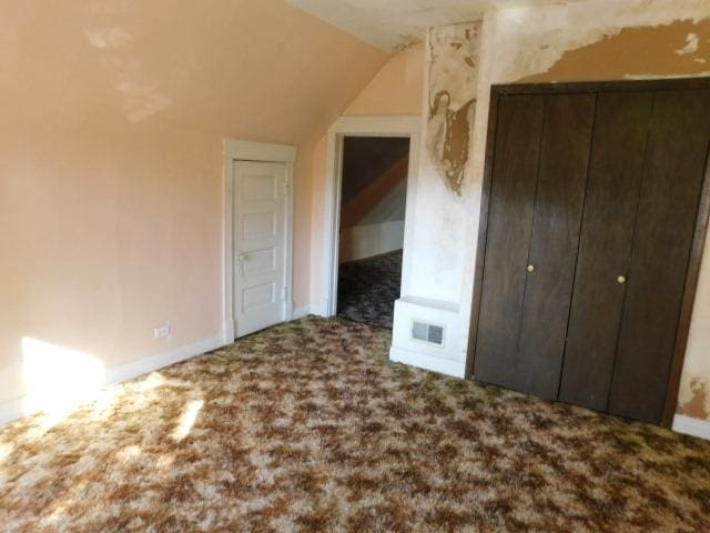 bonus room with lofted ceiling, carpet, and visible vents