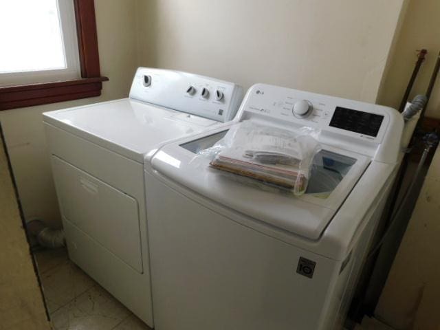 laundry room featuring washing machine and clothes dryer and laundry area