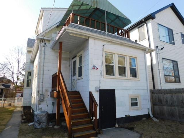 back of house featuring fence