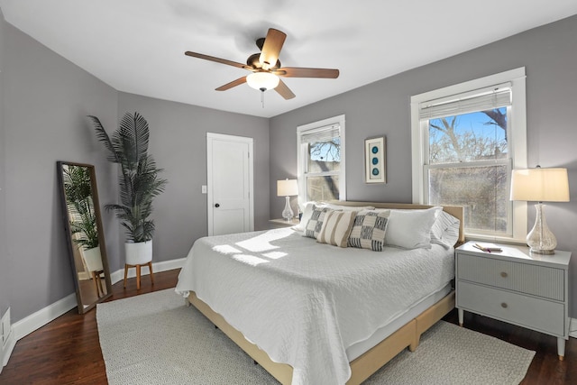 bedroom with baseboards, a ceiling fan, and dark wood-style flooring