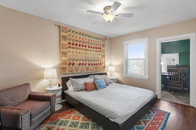 bedroom featuring baseboards, hardwood / wood-style floors, and a ceiling fan