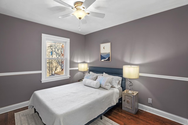 bedroom featuring ceiling fan, baseboards, and wood finished floors