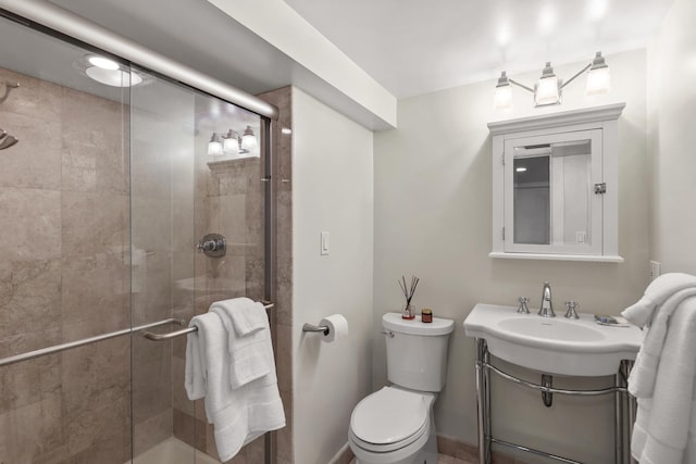 full bath featuring baseboards, toilet, a stall shower, and vanity