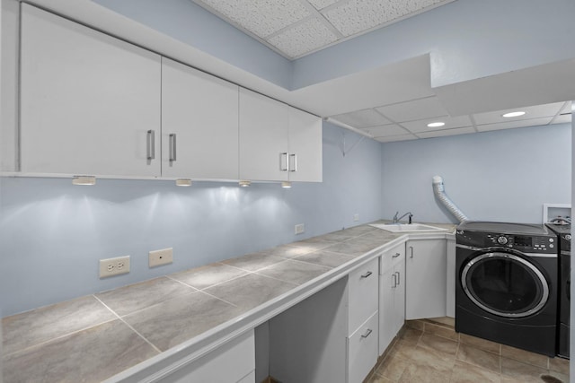 laundry area with a sink, cabinet space, and washer / dryer