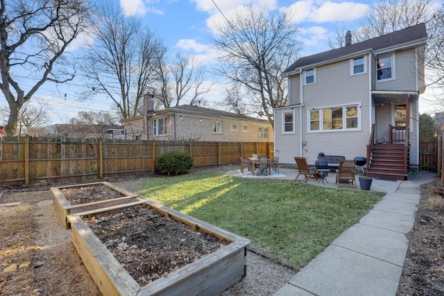 view of yard featuring a garden, fence, and a patio area