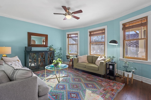 living area with a ceiling fan, crown molding, baseboards, and hardwood / wood-style floors