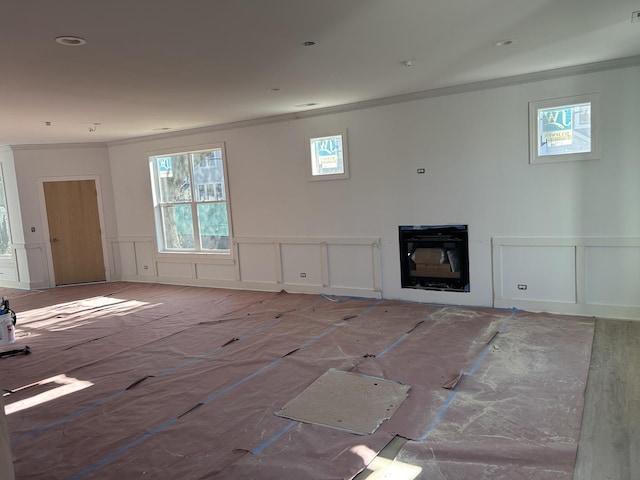 241 N Brockway St, Palatine, IL 60067 - unfurnished living room featuring crown molding, a decorative wall, wainscoting, plenty of natural light, and a glass covered fireplace