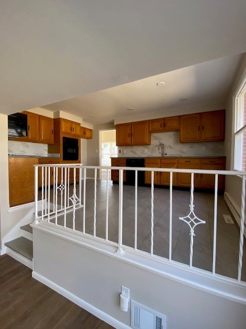 interior space with brown cabinetry, plenty of natural light, and visible vents