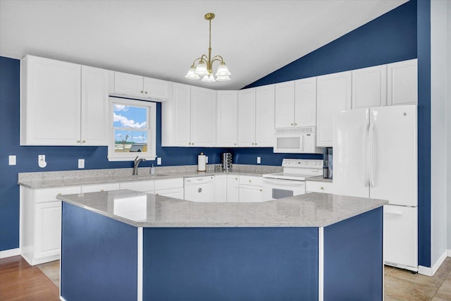 kitchen featuring vaulted ceiling, a notable chandelier, white cabinets, white appliances, and decorative light fixtures