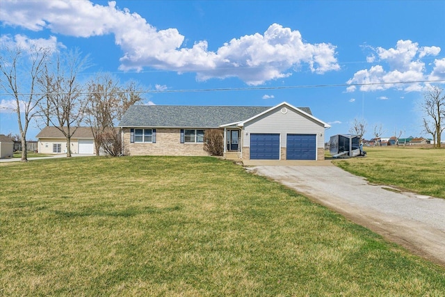 ranch-style house featuring driveway, brick siding, a garage, and a front lawn