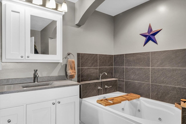 full bathroom featuring vanity and a whirlpool tub