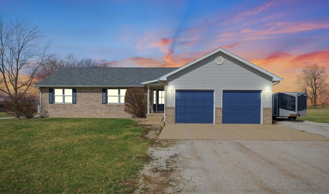 single story home featuring an attached garage, a front yard, brick siding, driveway, and a shingled roof
