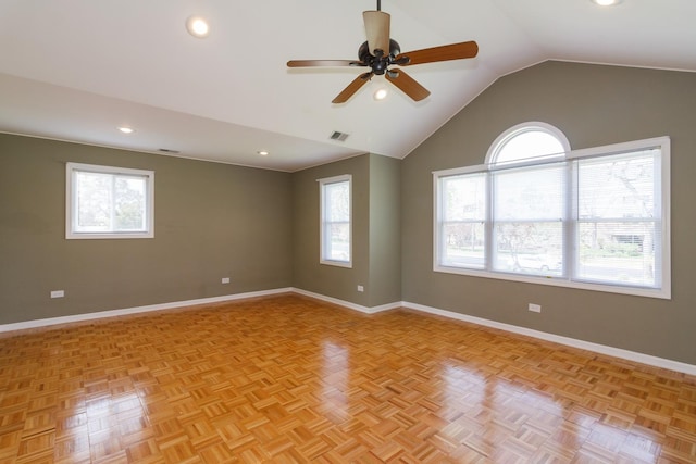 spare room with baseboards, lofted ceiling, and a healthy amount of sunlight