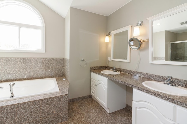 full bath featuring a sink, a shower with shower door, a garden tub, and double vanity