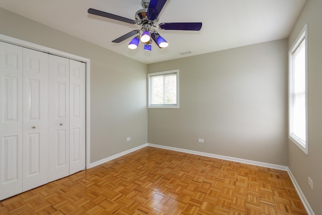 unfurnished bedroom with visible vents, baseboards, a closet, and a ceiling fan