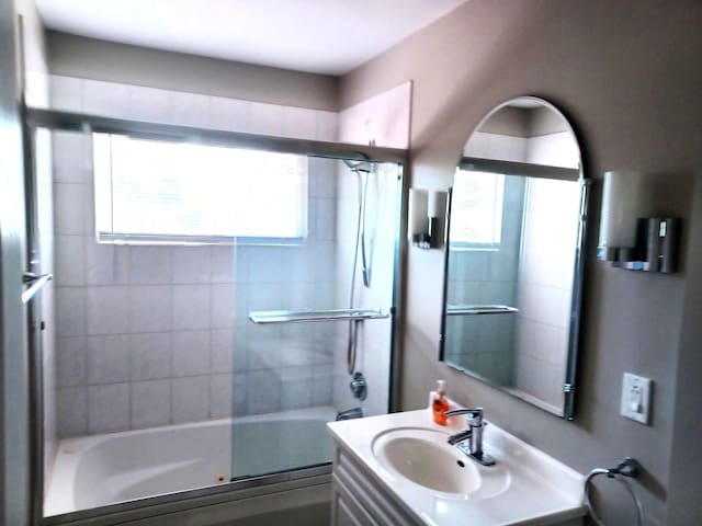 bathroom with vanity and shower / bath combination with glass door