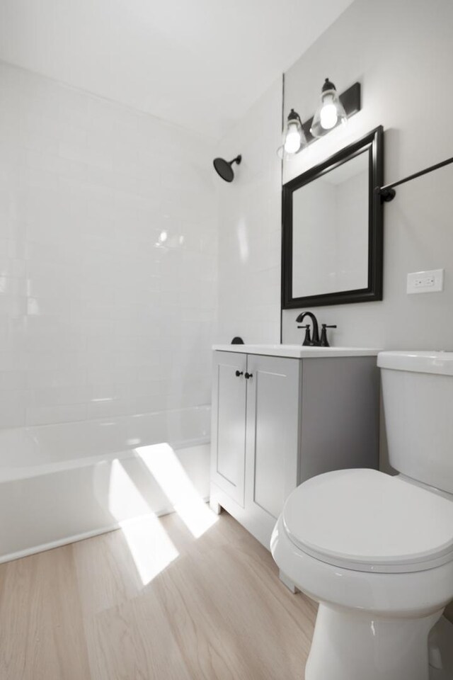 bathroom featuring vanity, toilet, and wood finished floors