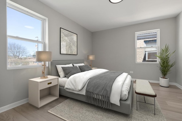 bedroom with light wood-type flooring and baseboards