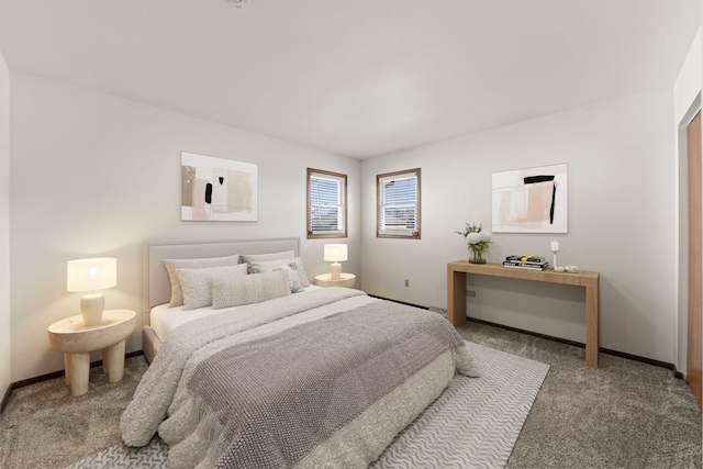 carpeted bedroom featuring baseboards