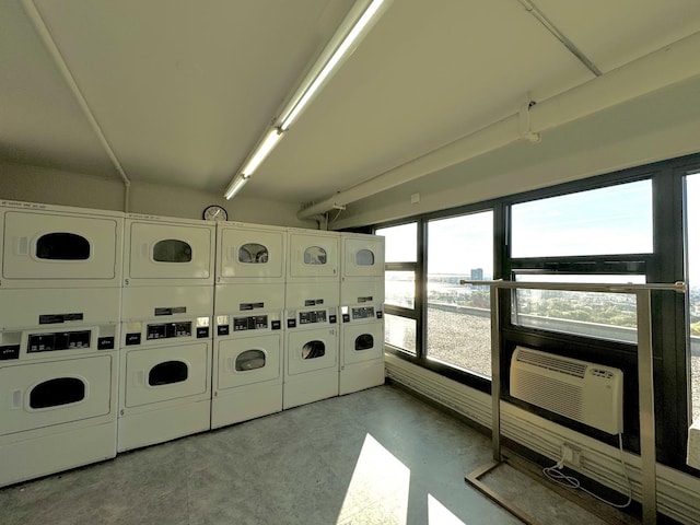 community laundry room featuring washer and clothes dryer, light floors, cooling unit, and stacked washing maching and dryer