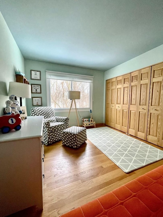 living area with baseboards and light wood finished floors