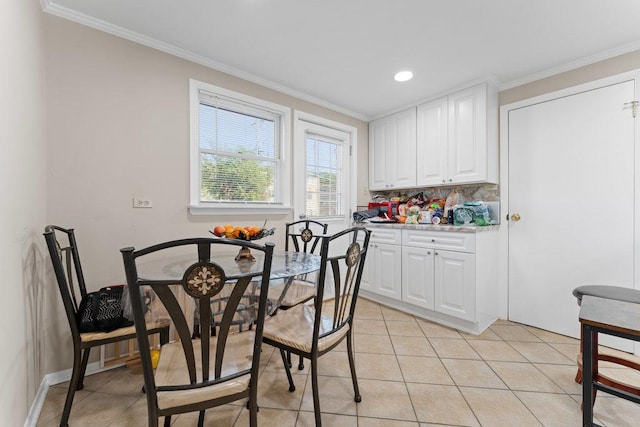 dining room with light tile patterned flooring, baseboards, and ornamental molding