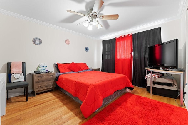 bedroom with ceiling fan, wood finished floors, and ornamental molding