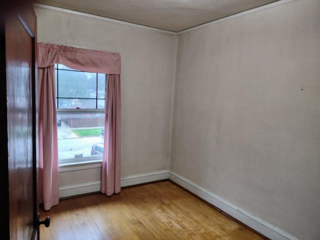 empty room featuring baseboards and light wood-style floors