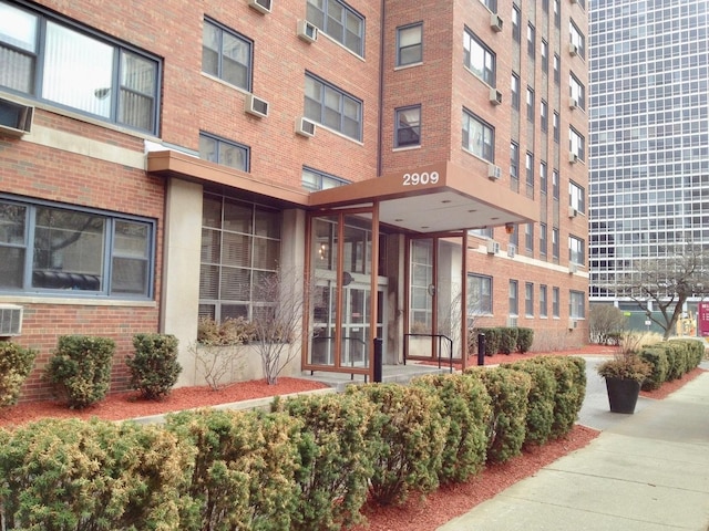 view of building exterior featuring an AC wall unit