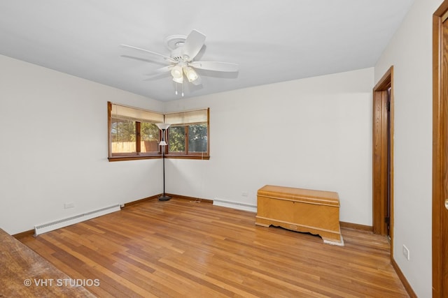 empty room with ceiling fan, baseboards, light wood-type flooring, and a baseboard radiator