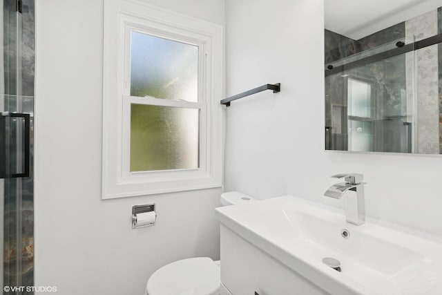 full bathroom with a sink, toilet, and a shower stall