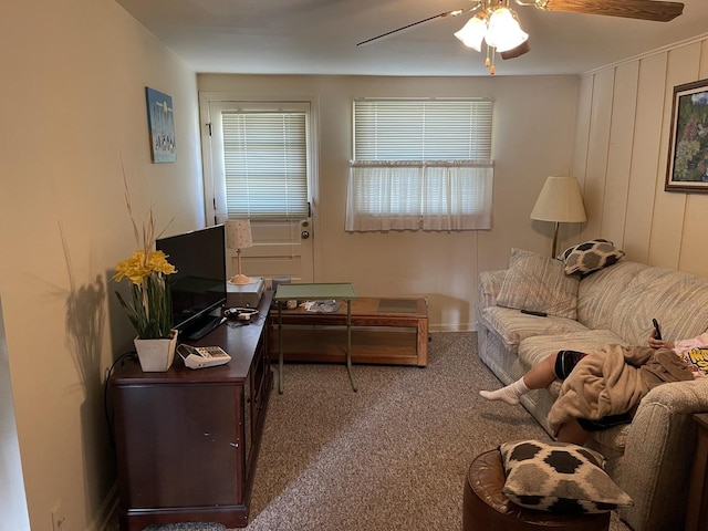 living area featuring ceiling fan and carpet flooring