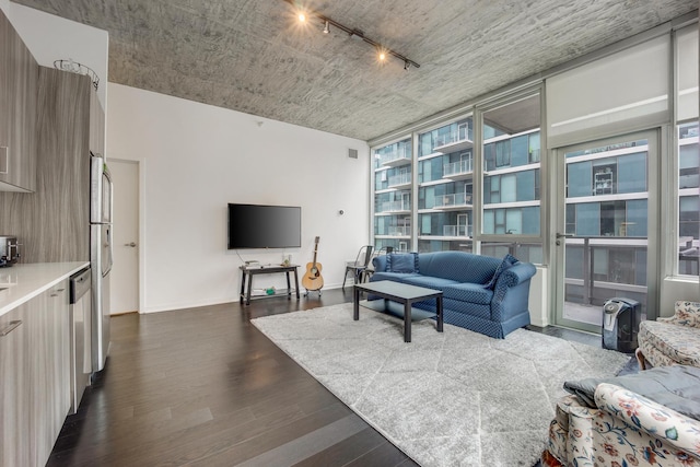 living area featuring visible vents, baseboards, dark wood-type flooring, and rail lighting