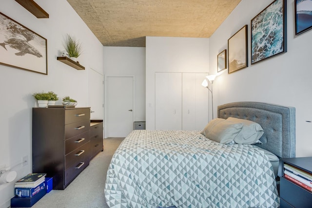 bedroom with a closet and light colored carpet