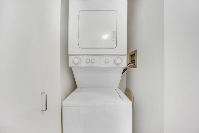 laundry room featuring laundry area and stacked washer / drying machine