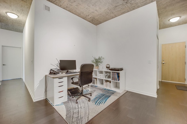 office featuring visible vents, baseboards, and wood finished floors