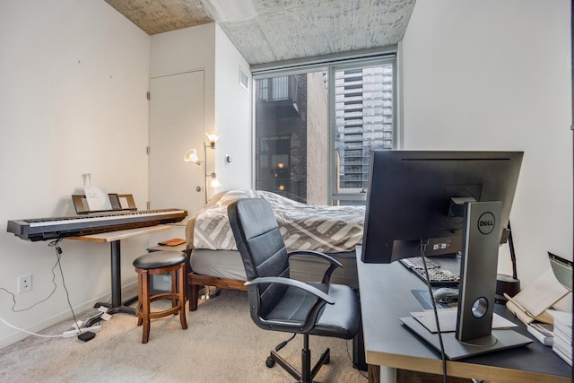 carpeted office featuring visible vents and baseboards