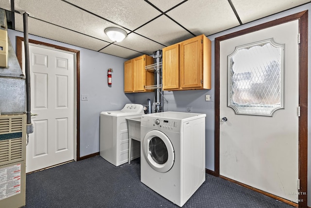 laundry room with baseboards, cabinet space, and independent washer and dryer