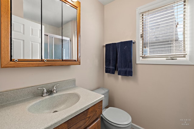 full bathroom featuring vanity, toilet, and a stall shower