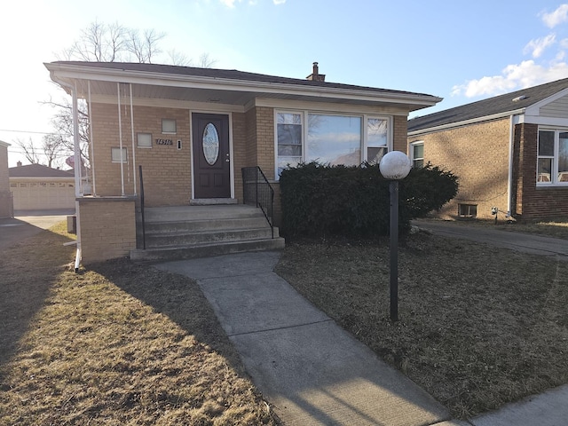 view of front facade featuring a porch and brick siding