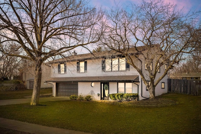 view of front of home with brick siding, fence, a lawn, a chimney, and driveway