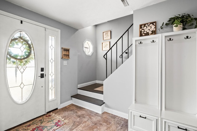 entrance foyer with stairway, baseboards, and visible vents