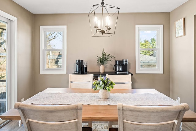 dining area featuring wood finished floors and a chandelier